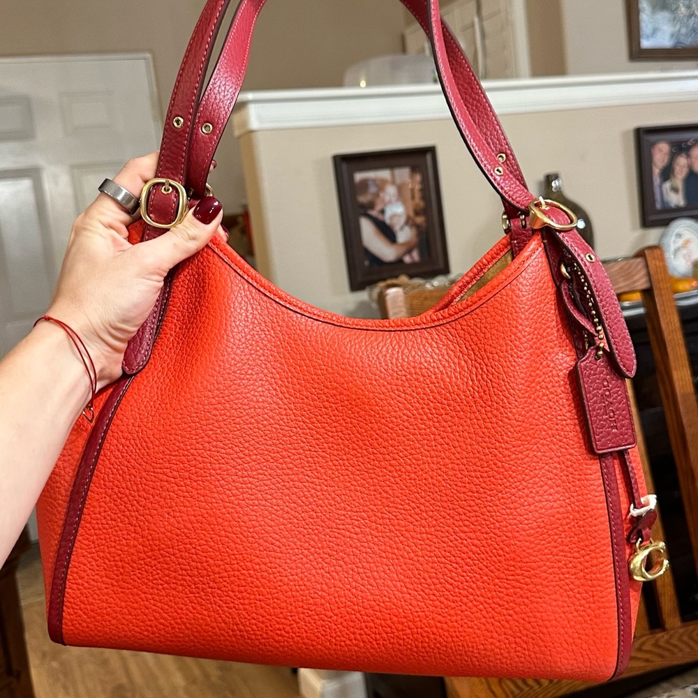 Brand new Lori Coach bag orange and red.